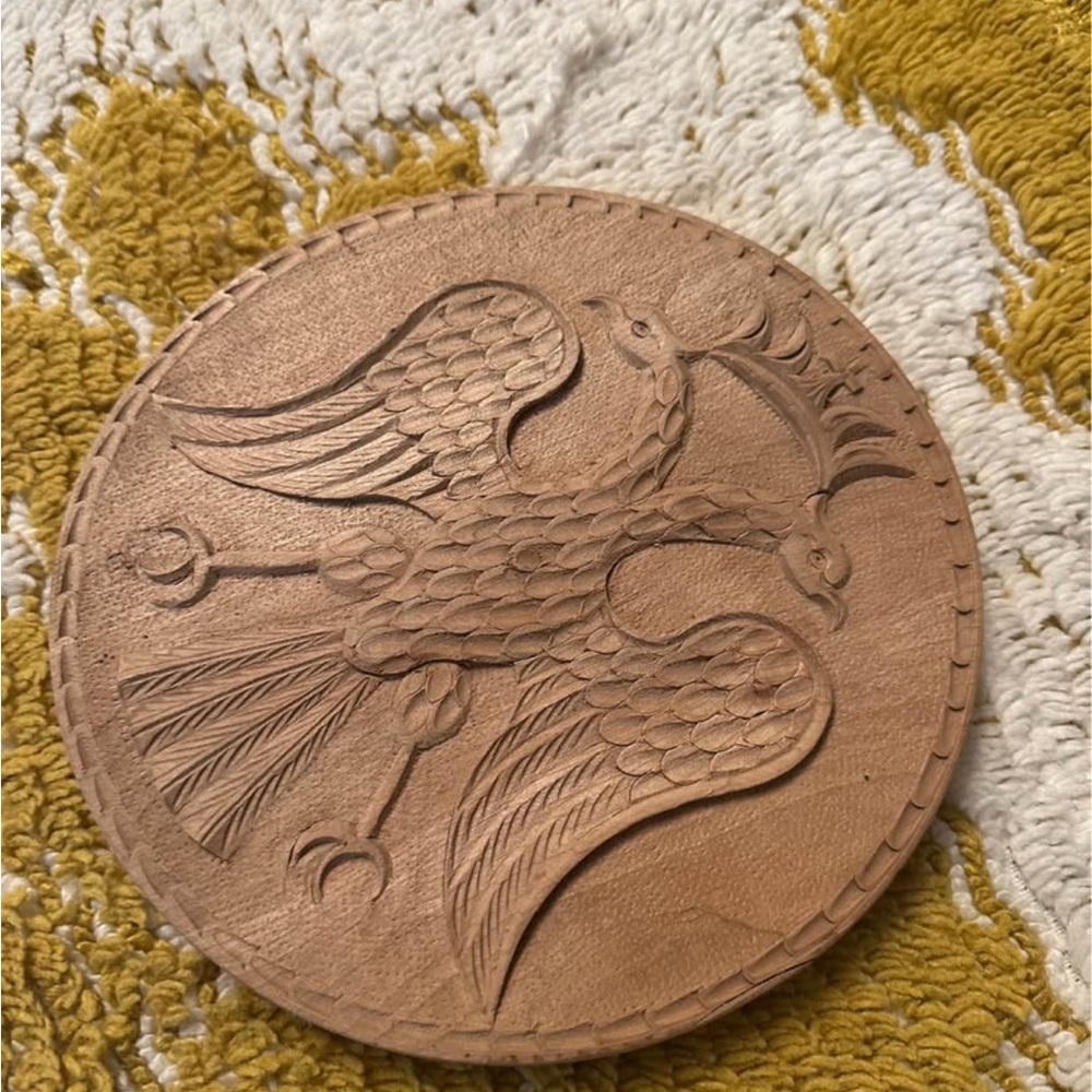 Hand-carved wooden plate featuring a Byzantine double-headed eagle.